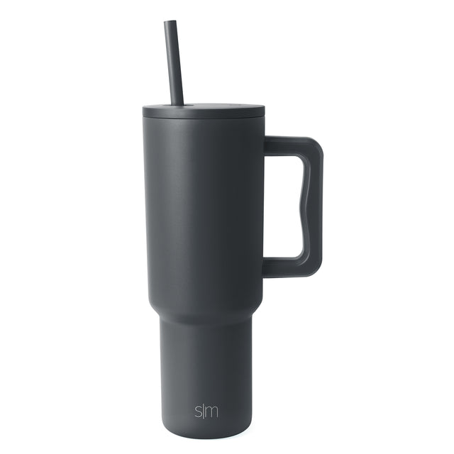 Charcoal gray Trek Tumbler with tapered cylindrical design, fitted lid, centered straw, and rectangular handle against white background Charcoal gray Trek Tumbler with tapered cylindrical design, fitted lid, centered straw, and rectangular handle against white background