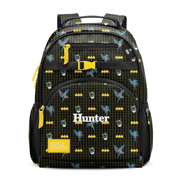 Batman-themed children's backpack with yellow bat symbols and logos on black ripstop nylon, featuring yellow accents, multiple pockets, padded handles, and Batman-themed children's backpack with yellow bat symbols and logos on black ripstop nylon, featuring yellow accents, multiple pockets, padded handles, and