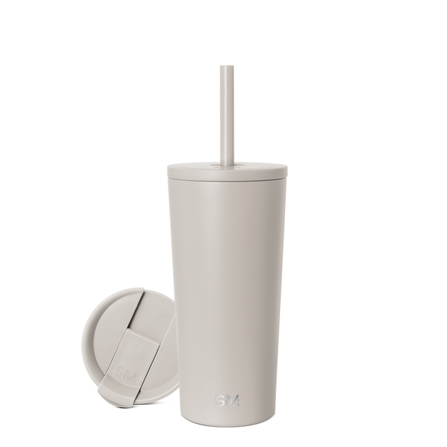 Beige cylindrical tumbler with matching lid on neutral background Beige cylindrical tumbler with matching lid on neutral background