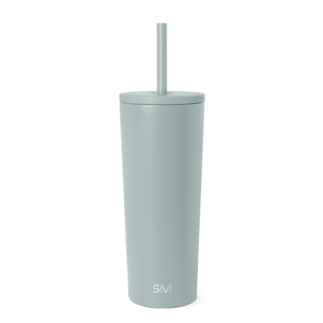 Sage green cylindrical tumbler with fitted lid and matching straw on white background. White Sage green cylindrical tumbler with fitted lid and matching straw on white background. White