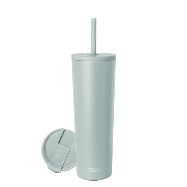Sage green cylindrical tumbler with matching lid and straw on neutral background Sage green cylindrical tumbler with matching lid and straw on neutral background