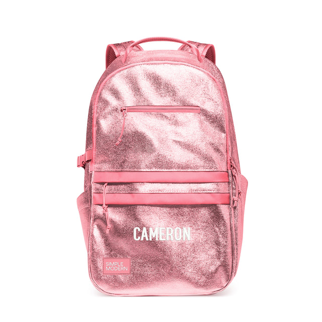 Rose pink metallic children's backpack with padded shoulder straps, carry handle, front zippered pockets, and side compression straps. Features Rose pink metallic children's backpack with padded shoulder straps, carry handle, front zippered pockets, and side compression straps. Features
