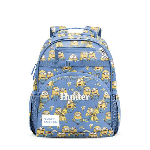 Periwinkle blue children's backpack with all-over Minion and banana print, featuring padded carry handle, front zippered pocket, side mesh pockets, and quick-release buckle strap. Simple Modern Hunter brand. Periwinkle blue children's backpack with all-over Minion and banana print, featuring padded carry handle, front zippered pocket, side mesh pockets, and quick-release buckle strap. Simple Modern Hunter brand.