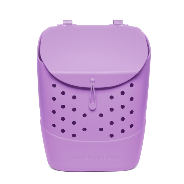 Lavender purple Simple Modern backpack with perforated circular pattern, carry handles, rounded top flap with toggle closure, and embossed logo on white background. Lavender purple Simple Modern backpack with perforated circular pattern, carry handles, rounded top flap with toggle closure, and embossed logo on white background.