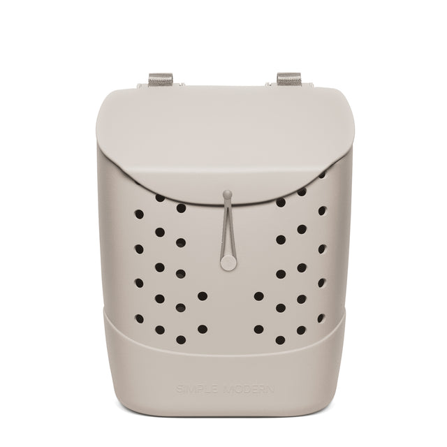 Beige minimalist backpack with black perforated circular pattern, silver textured handles, gray cord pull, and Beige minimalist backpack with black perforated circular pattern, silver textured handles, gray cord pull, and