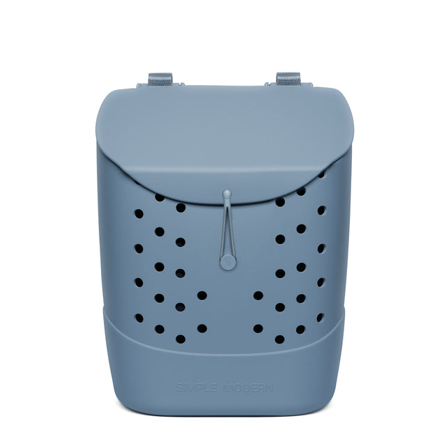 Slate blue Simple Modern backpack with perforated ventilation holes, gray drawstring closure, carrying handles, and horizontal seam detail on white background. Slate blue Simple Modern backpack with perforated ventilation holes, gray drawstring closure, carrying handles, and horizontal seam detail on white background.