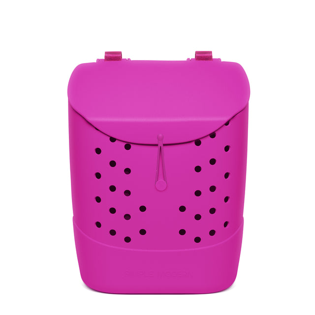 Magenta rounded backpack with black circular perforations, padded shoulder straps, and drawstring closure on white background. Magenta rounded backpack with black circular perforations, padded shoulder straps, and drawstring closure on white background.
