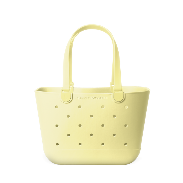 Soft butter yellow tote bag with sage green perforated dot detailing throughout Soft butter yellow tote bag with sage green perforated dot detailing throughout