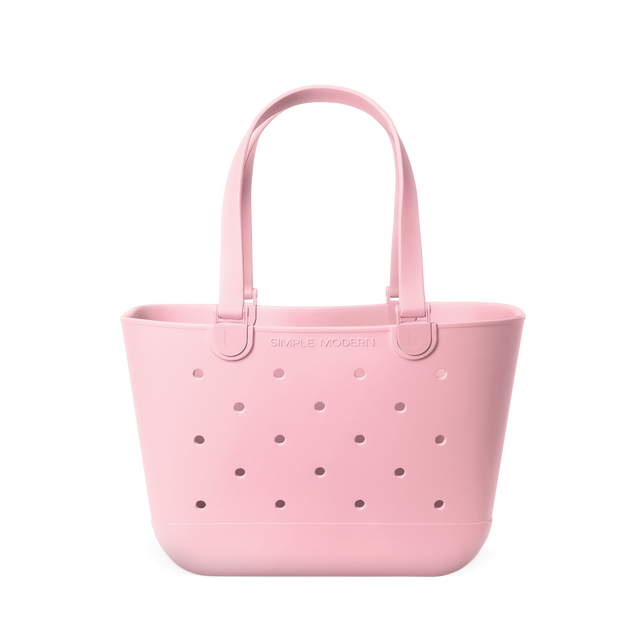 Soft pale pink tote bag with mauve perforated detailing across the front for subtle contrast Soft pale pink tote bag with mauve perforated detailing across the front for subtle contrast