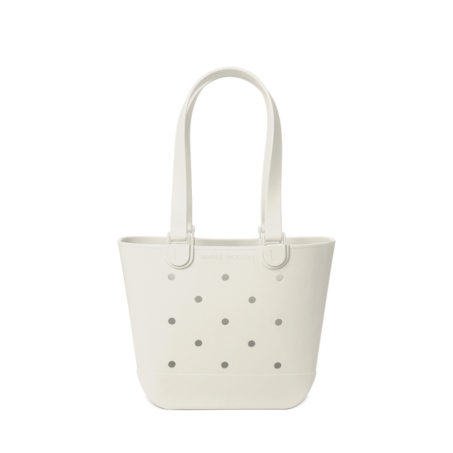 Cream-colored canvas tote bag with gray perforated details against a white background Cream-colored canvas tote bag with gray perforated details against a white background