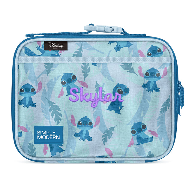 Light blue insulated lunch box featuring Disney's Stitch character in multiple poses with tropical leaf designs. Includes top zipper closure, front mesh pocket, dual carry handles, and magenta Light blue insulated lunch box featuring Disney's Stitch character in multiple poses with tropical leaf designs. Includes top zipper closure, front mesh pocket, dual carry handles, and magenta