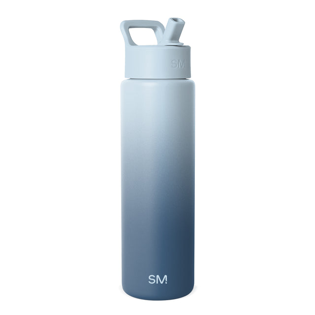 Powder blue to slate blue gradient insulated water bottle with integrated carry handle and flip-top spout. SM logo on cap and lower body. Studio product photo on white background. Powder blue to slate blue gradient insulated water bottle with integrated carry handle and flip-top spout. SM logo on cap and lower body. Studio product photo on white background.