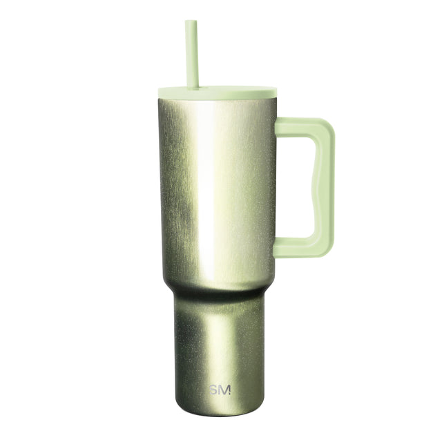Insulated tumbler with metallic gradient finish transitioning from charcoal gray to sage green, matching lid and reusable straw, curved handle, Simple Modern logo, white background. Insulated tumbler with metallic gradient finish transitioning from charcoal gray to sage green, matching lid and reusable straw, curved handle, Simple Modern logo, white background.