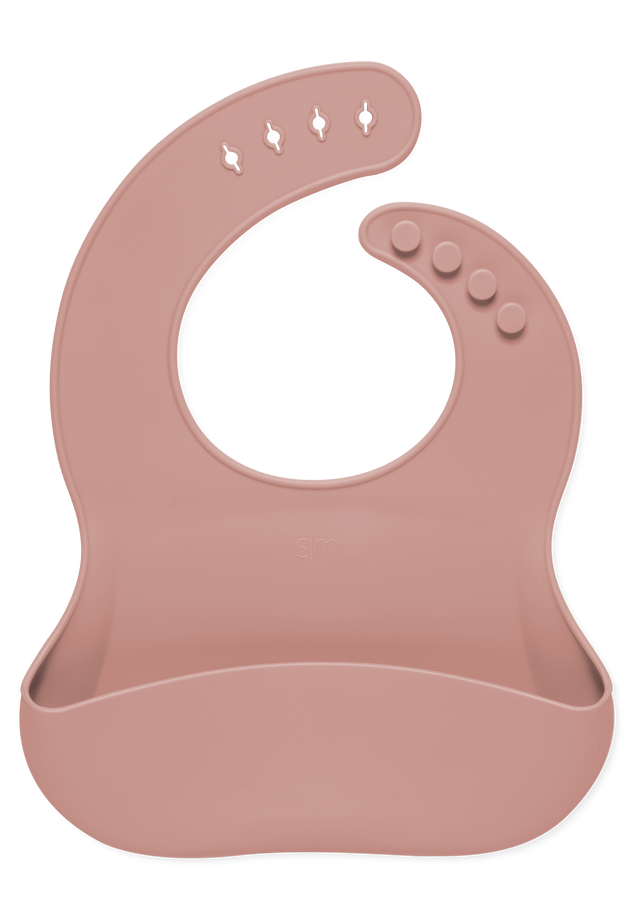Dusty rose mauve baby bib displayed against a white background Dusty rose mauve baby bib displayed against a white background