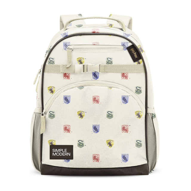 Simple Modern cream backpack with dark brown accents, multiple zippered compartments, decorative logo pattern with shields and crests in red, blue, and yellow, padded mesh shoulder straps, and top webbing handle, shown