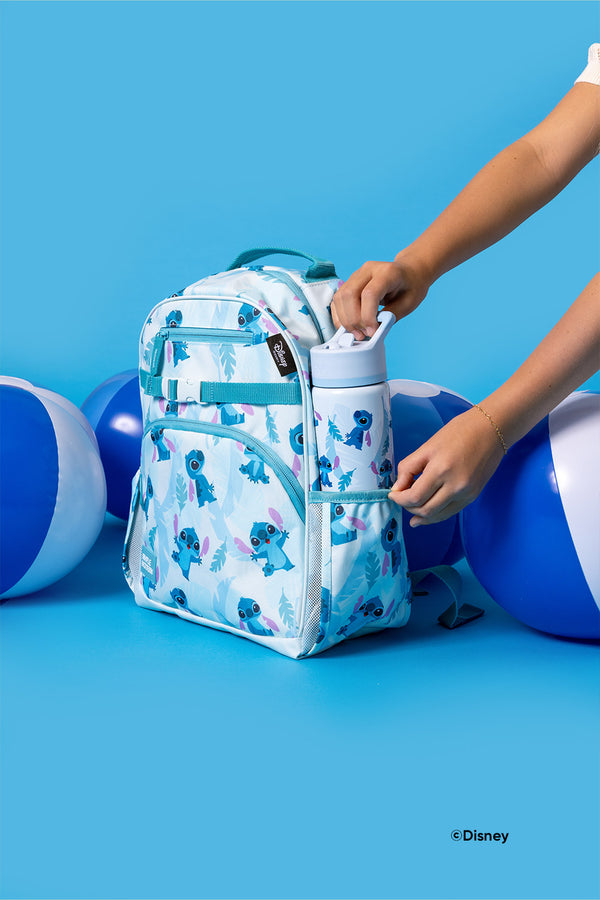 Disney Stitch children's backpack with white base and teal blue and purple character pattern, featuring matching water bottle, displayed against blue background.