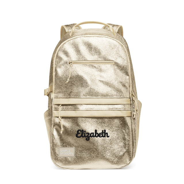 Champagne gold metallic backpack with cream straps, front elastic bands, padded shoulder straps, and mesh ventilation panels. Features 
