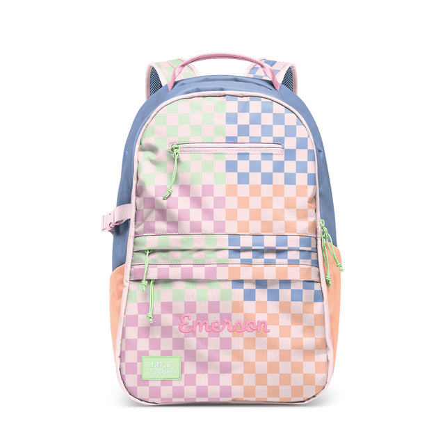Pastel gradient children's backpack with checkerboard pattern featuring pink, mint green, and periwinkle colors. Features padded shoulder straps, front zippered compartments, and 