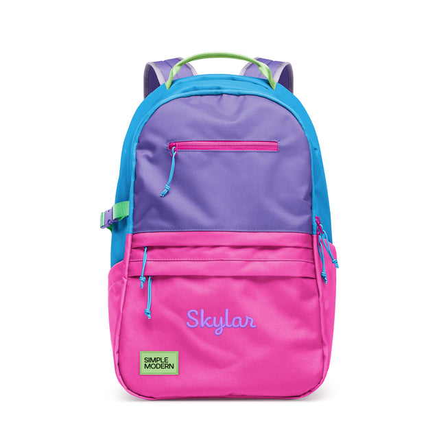 Colorful children's backpack with bright pink lower section, purple upper compartment, blue side panels, and lime green handles, featuring multiple zippered pockets and 