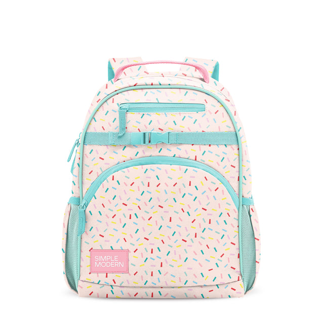 Pale pink children's backpack with turquoise trim, colorful confetti pattern, front pocket with 