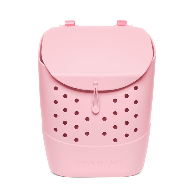 Pale pink insulated backpack with rounded silhouette, curved top flap, burgundy ventilation holes on lower front, top handles, and Simple Modern branding, shown front-facing against white background.