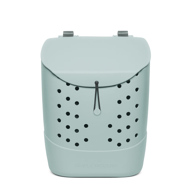 Sage green drawstring backpack with black ventilation holes, gray shoulder straps, and 