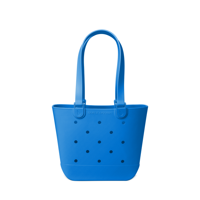 Royal blue tote bag with navy polka dots on off-white background