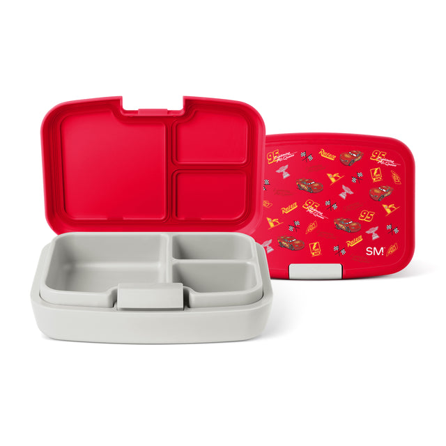 Red and white Simple Modern bento lunchbox with Cars-themed design, shown open and closed. Features multiple compartments, carrying handle, and gold accents on lid against neutral background.