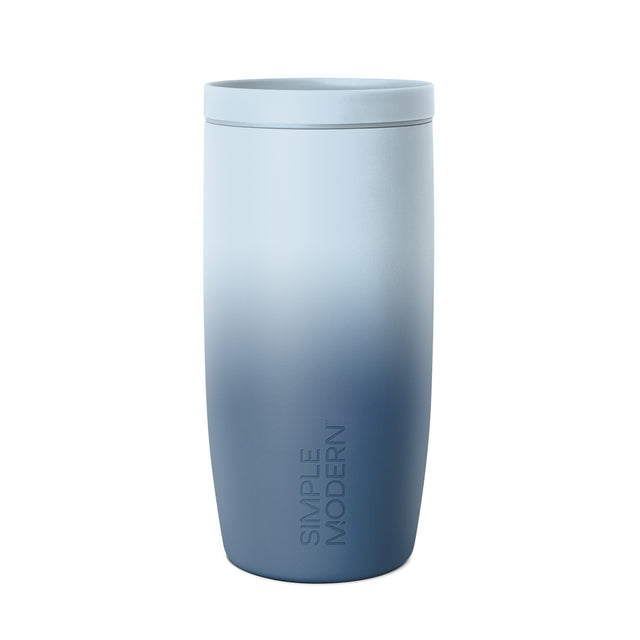 Tall cylindrical tumbler with matching lid in ombre gradient from pale blue to navy blue, featuring 