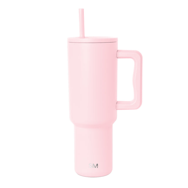 Soft pink insulated tumbler with handle and matching straw on white background. Simple Modern logo visible on lower front. Modern minimalist design with cylindrical shape and fitted lid.