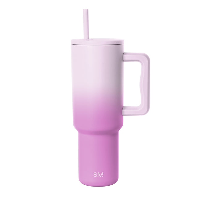 Simple Modern insulated tumbler with lavender-to-magenta ombre gradient, featuring a handle, matching lid with straw, and SM logo on white background.
