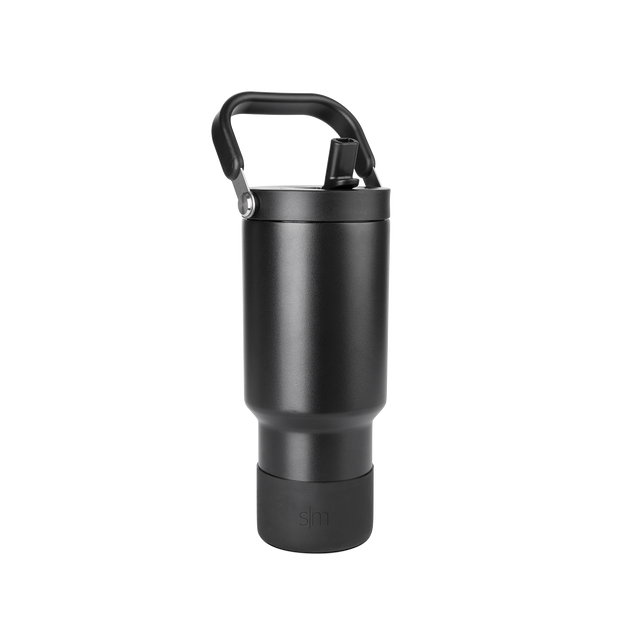 Matte black cylindrical drinkware with metallic gray accents and dark handle against black background