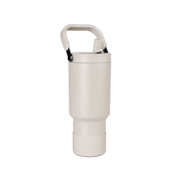 Pale beige cylindrical vessel with cream-colored closure cap on neutral off-white background.