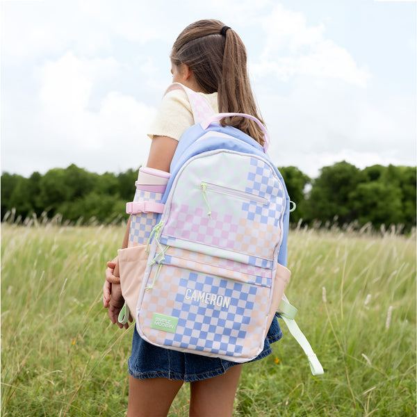 Girl wearing personalized Simple Modern backpack with pastel checkerboard pattern and 