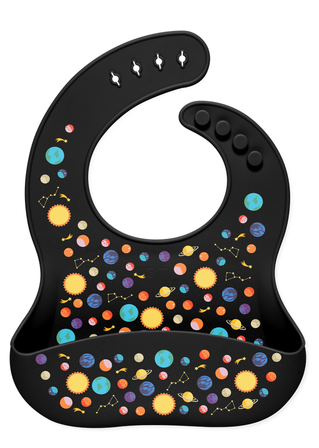 Black background with colorful celestial elements including bright yellow suns and stars, cyan and light blue planets, orange and coral circular shapes, and pink accents arranged in a decorative pattern