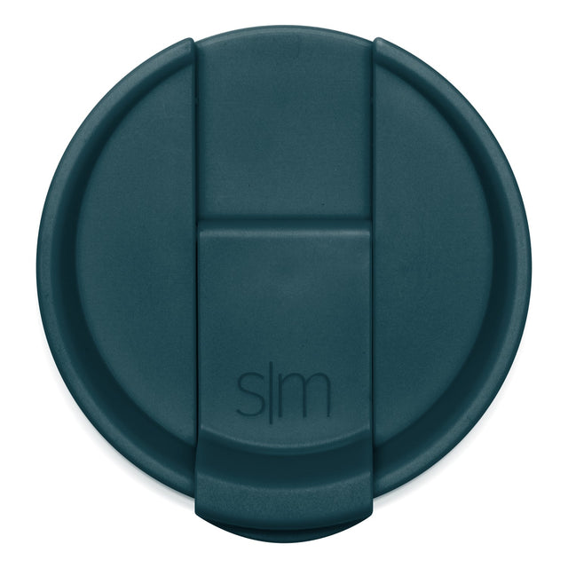 Teal-colored circular lid with raised rim, photographed from above against white background.